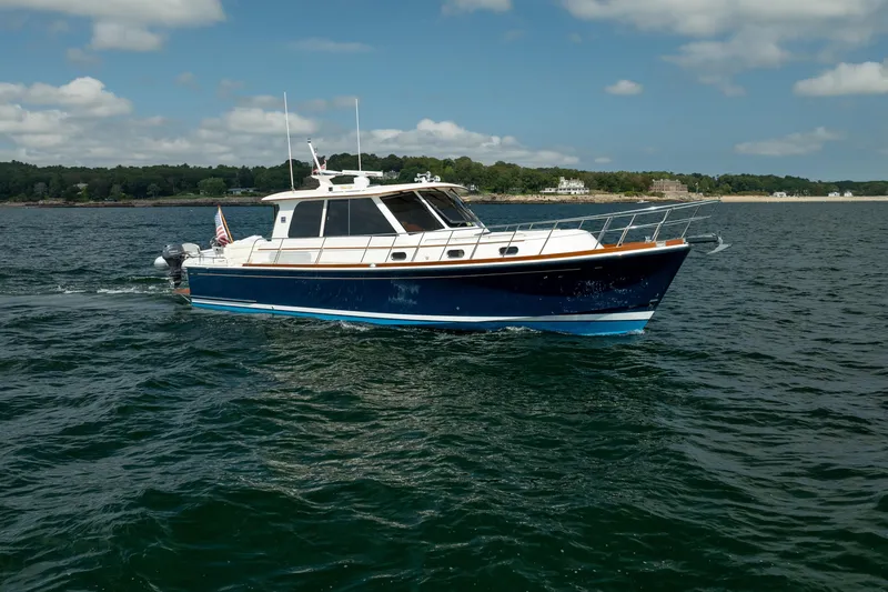 Whole Life Yacht Photos Pics 2011 Grand Banks 46 Eastbay SX yacht cruising on open water under a partly cloudy sky.