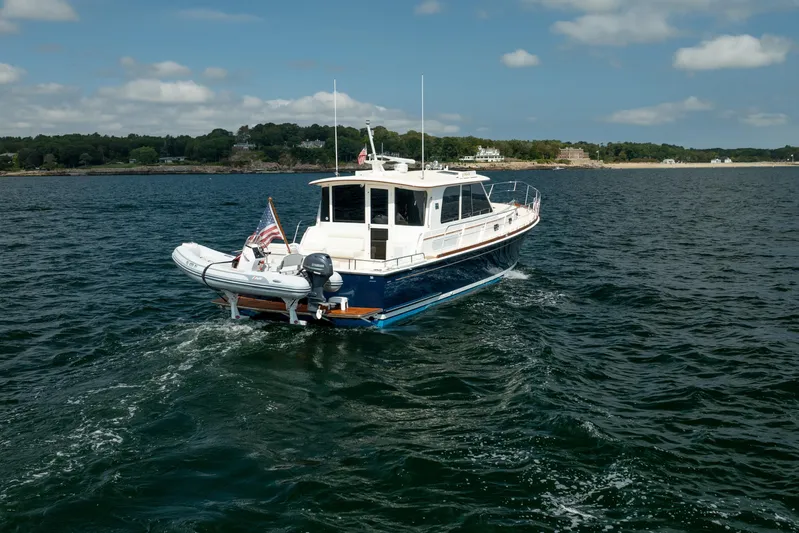 Whole Life Yacht Photos Pics 2011 Grand Banks 46 Eastbay SX cruising on open water under a clear sky.