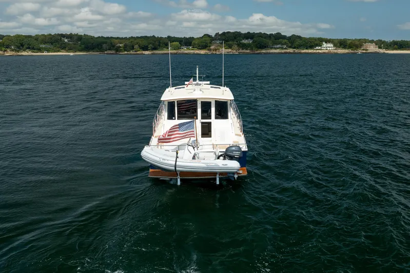 Whole Life Yacht Photos Pics 2011 Grand Banks 46 Eastbay SX yacht cruising on open water with American flag.