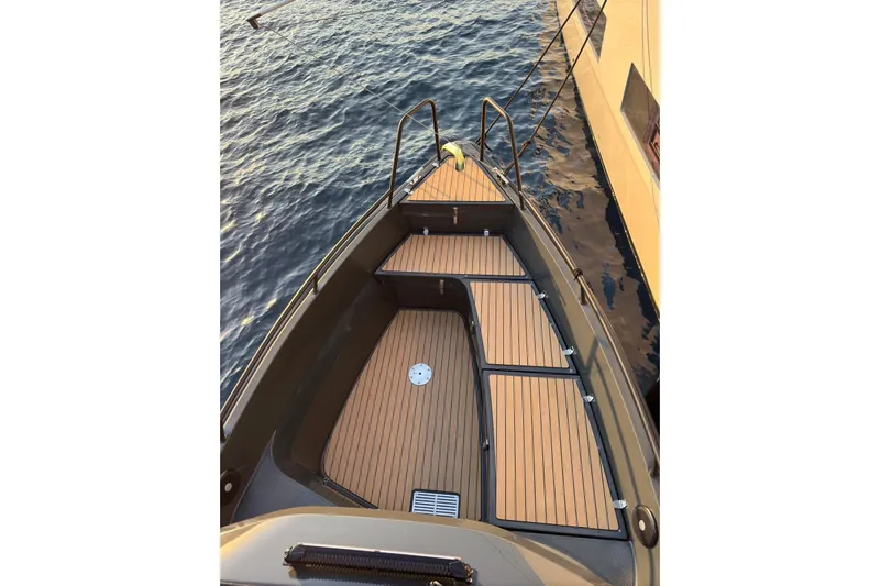  Yacht Photos Pics Bow view of 2021 XO EXPLORER 10S boat with wooden deck on calm water.
