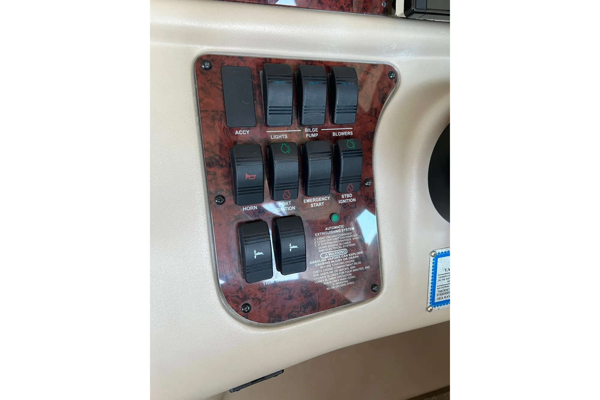 Control panel of a 1999 Sea Ray 290 Sundancer boat with various switches.