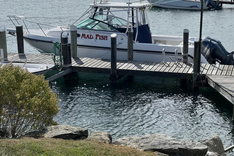 Mad Fish Yacht Photos Pics 2001 Boston Whaler 28 Conquest boat docked at marina, named "Mad Fish."