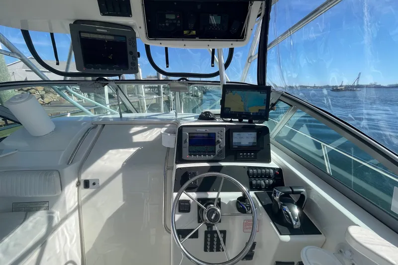Mad Fish Yacht Photos Pics 2001 Boston Whaler 28 Conquest helm with navigation equipment and ocean view.