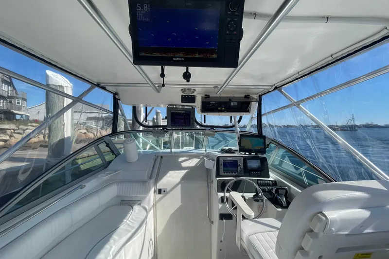 Mad Fish Yacht Photos Pics Interior view of 2001 Boston Whaler 28 Conquest boat with navigation equipment and seating.