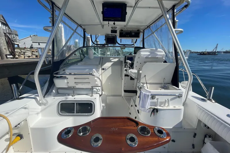Mad Fish Yacht Photos Pics 2001 Boston Whaler 28 Conquest boat interior with helm, seating, and fishing amenities.