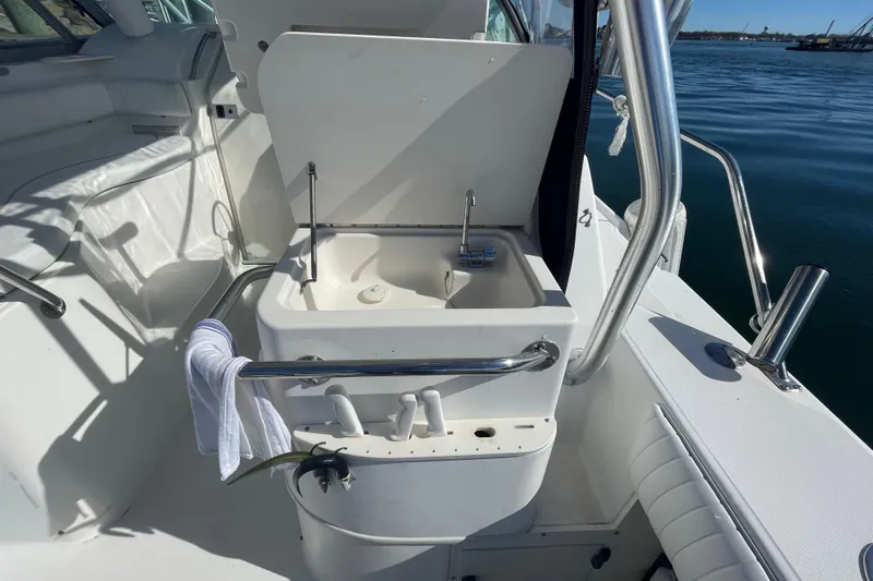 Mad Fish Yacht Photos Pics Boston Whaler 28 Conquest 2001 boat sink with faucet, docked by the water.