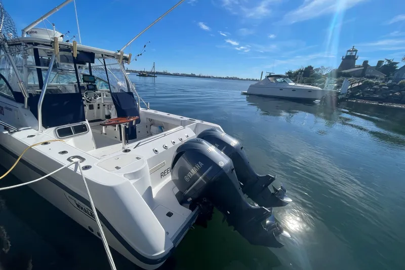 Mad Fish Yacht Photos Pics 2001 Boston Whaler 28 Conquest boat docked with dual Yamaha outboard engines.