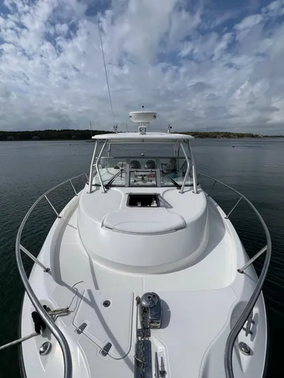  Yacht Photos Pics 2011 Boston Whaler 305 Conquest boat on calm water under cloudy sky.