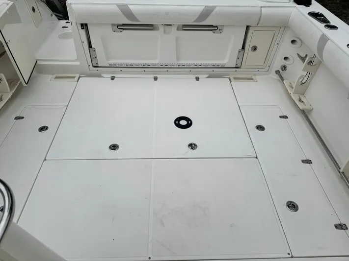  Yacht Photos Pics 2011 Boston Whaler 305 Conquest boat deck, featuring storage compartments and clean white surface.