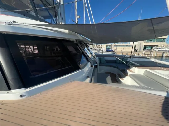 Tbd Yacht Photos Pics 2022 Fountaine Pajot Samana 59 yacht with sleek deck and shaded seating area.