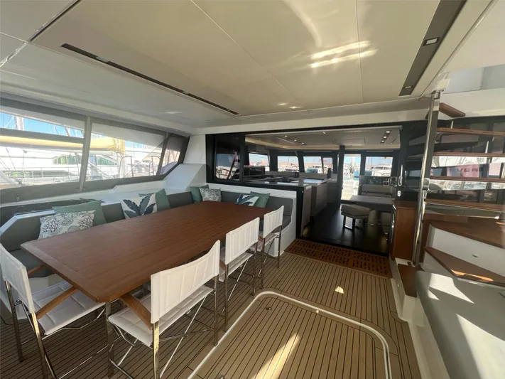 Tbd Yacht Photos Pics Luxurious interior of 2022 Fountaine Pajot Samana 59 catamaran with dining area and modern design.