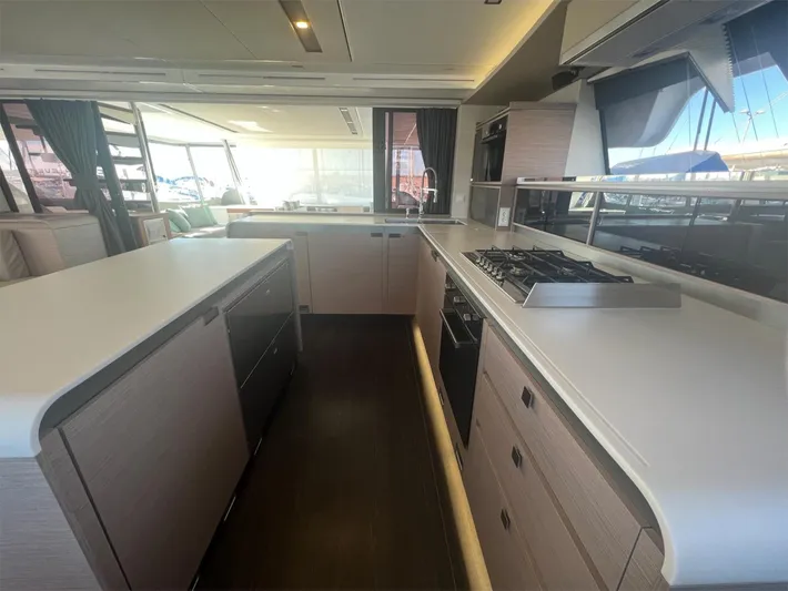 Tbd Yacht Photos Pics Modern kitchen interior of 2022 Fountaine Pajot Samana 59 yacht, featuring sleek countertops and appliances.