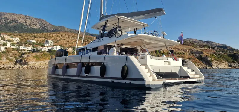 Tbd Yacht Photos Pics Luxury 2022 Fountaine Pajot Samana 59 catamaran anchored near scenic coastline.