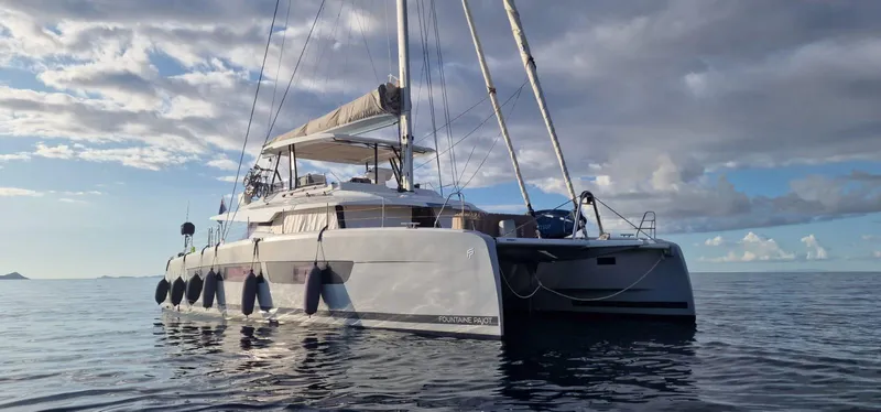 Tbd Yacht Photos Pics 2022 Fountaine Pajot Samana 59 catamaran sailing on calm ocean waters.