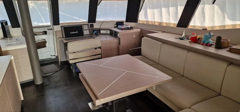 Tbd Yacht Photos Pics Luxurious interior of 2022 Fountaine Pajot Samana 59 yacht with modern seating and navigation equipment.