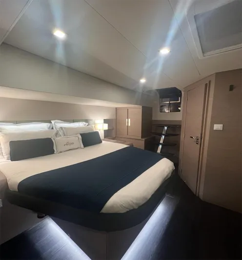 Tbd Yacht Photos Pics Luxurious bedroom interior of 2022 Fountaine Pajot Samana 59 yacht, featuring modern design and ambient lighting.
