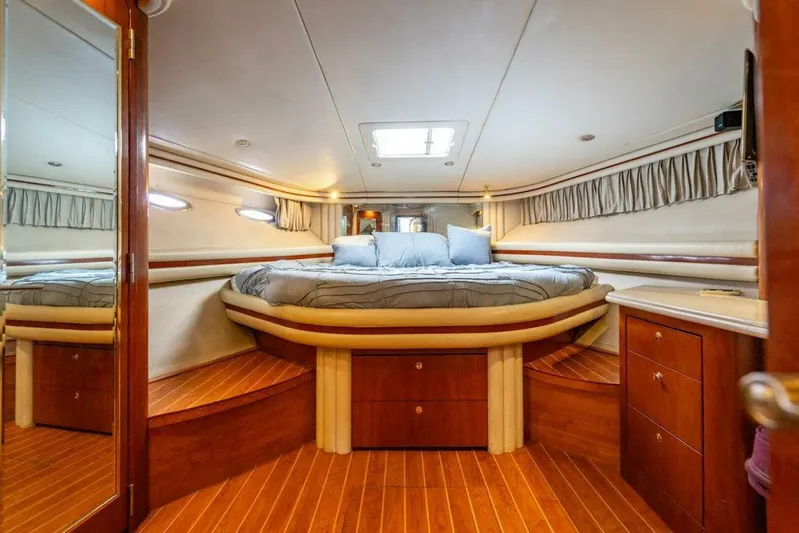 Southern Seas Yacht Photos Pics Luxurious cabin interior of 1999 Sea Ray 56 Sedan Bridge yacht with wood accents and cozy bedding.