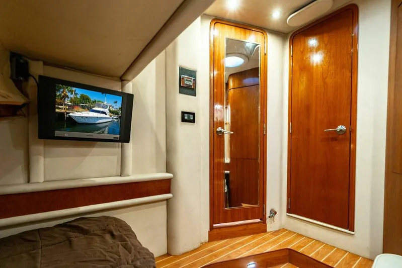 Southern Seas Yacht Photos Pics Interior of 1999 Sea Ray 56 Sedan Bridge with wood paneling and mounted TV.