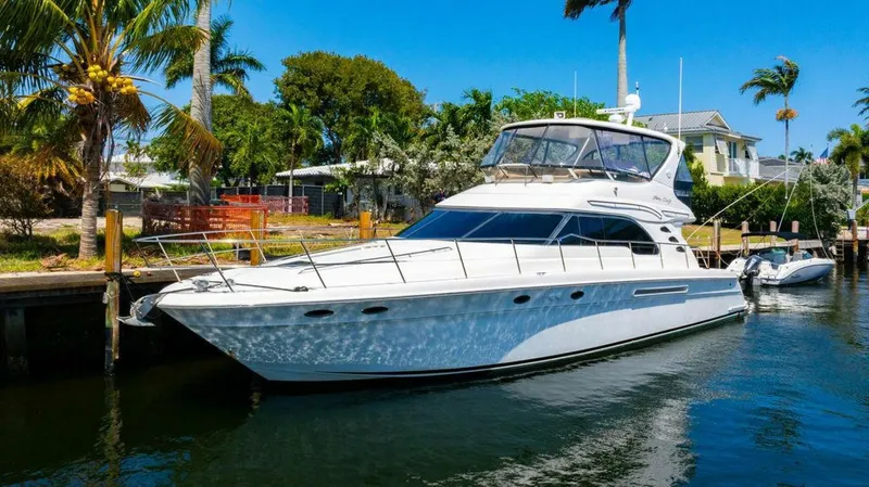 Southern Seas Yacht Photos Pics 1999 Sea Ray 56 Sedan Bridge yacht docked in a tropical marina setting.