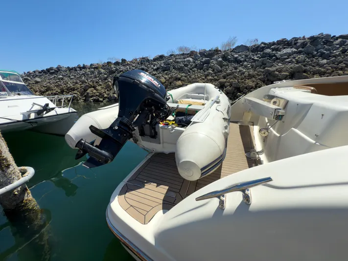 Italian Job Yacht Photos Pics 2001 Cranchi Atlantique yacht with inflatable boat and outboard motor on deck.