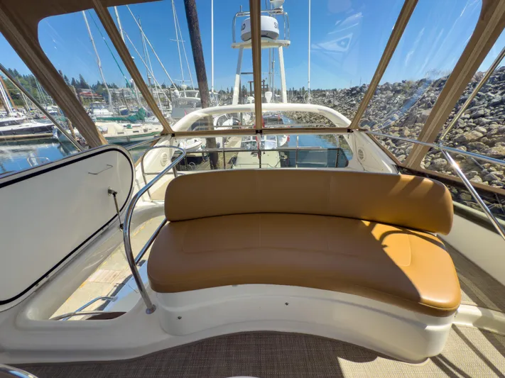 Italian Job Yacht Photos Pics 2001 Cranchi Atlantique yacht interior with tan seating and marina view.