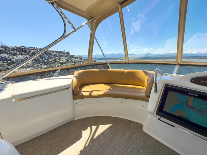 Italian Job Yacht Photos Pics Interior view of 2001 Cranchi Atlantique yacht with tan seating and navigation display.