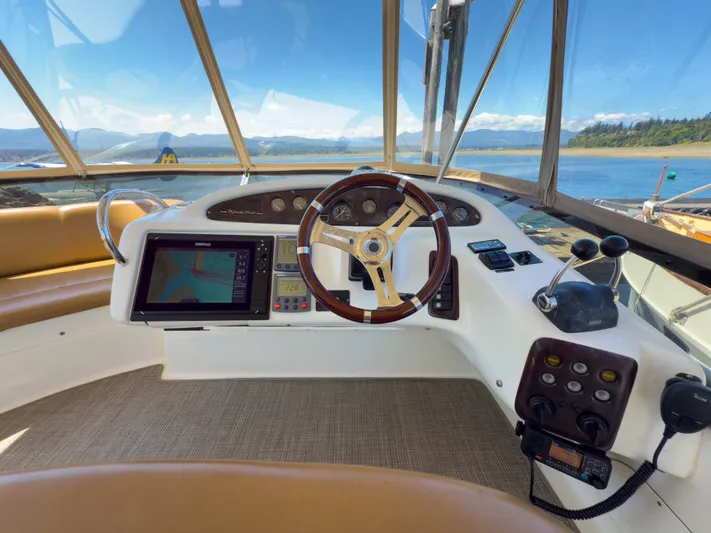 Italian Job Yacht Photos Pics 2001 Cranchi Atlantique yacht helm with navigation system and scenic water view.