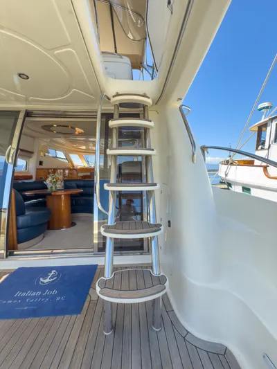 Italian Job Yacht Photos Pics Staircase on 2001 Cranchi Atlantique yacht, leading to upper deck, with interior view.