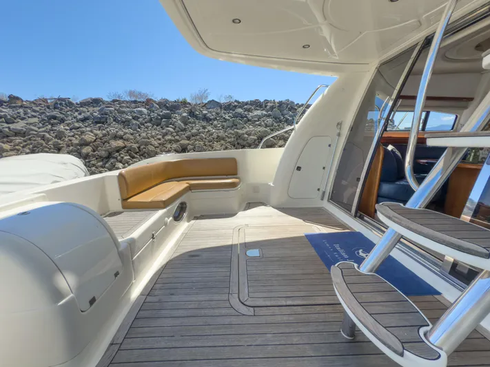 Italian Job Yacht Photos Pics 2001 Cranchi Atlantique yacht deck with seating and stairs, under clear blue sky.