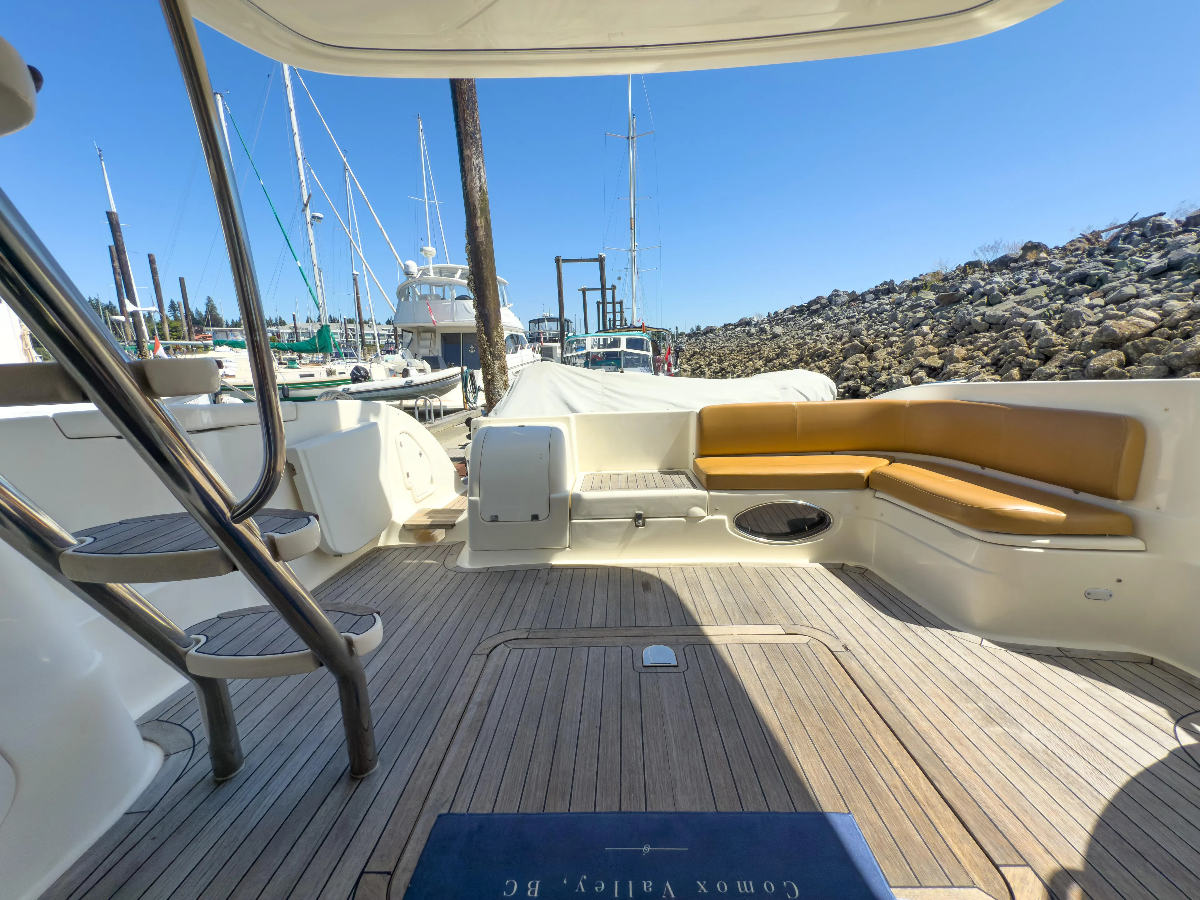 Italian Job Yacht Photos Pics 2001 Cranchi Atlantique yacht deck with seating, docked at marina under clear blue sky.