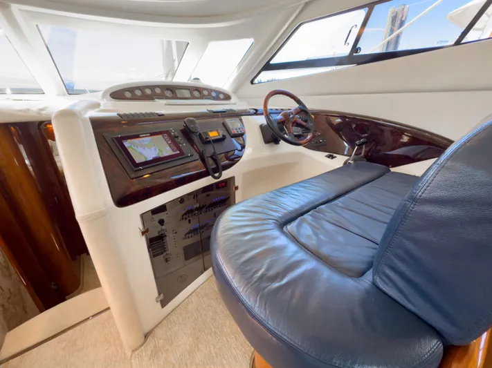 Italian Job Yacht Photos Pics 2001 Cranchi Atlantique yacht helm with leather seating and navigation controls.