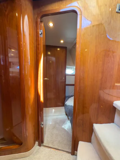 Italian Job Yacht Photos Pics Interior of 2001 Cranchi Atlantique yacht with polished wood and cozy cabin.