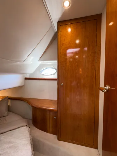 Italian Job Yacht Photos Pics Interior of 2001 Cranchi Atlantique yacht with wooden cabinetry and cozy seating area.