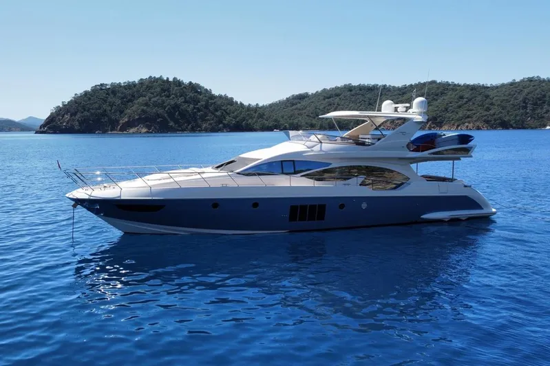  Yacht Photos Pics Azimut 70 yacht from 2010 cruising on serene blue waters with scenic island backdrop.