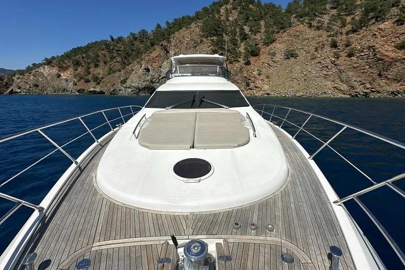  Yacht Photos Pics Luxury Azimut 70 yacht from 2010 cruising near scenic rocky coastline.