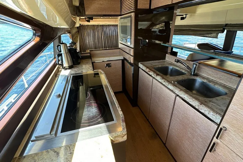  Yacht Photos Pics Luxurious kitchen interior of a 2010 Azimut 70 yacht with modern appliances.