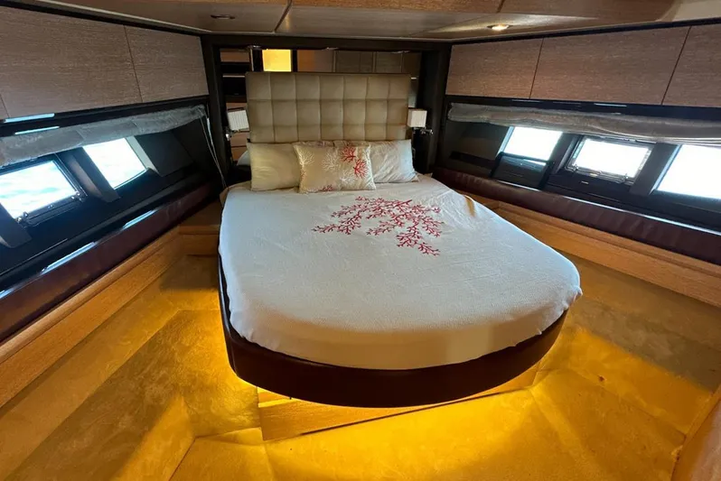  Yacht Photos Pics Luxurious bedroom interior of 2010 Azimut 70 yacht with elegant bedding and ambient lighting.