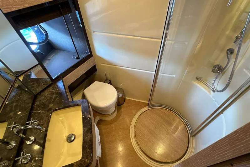  Yacht Photos Pics Luxurious bathroom in 2010 Azimut 70 yacht with shower, sink, and toilet.