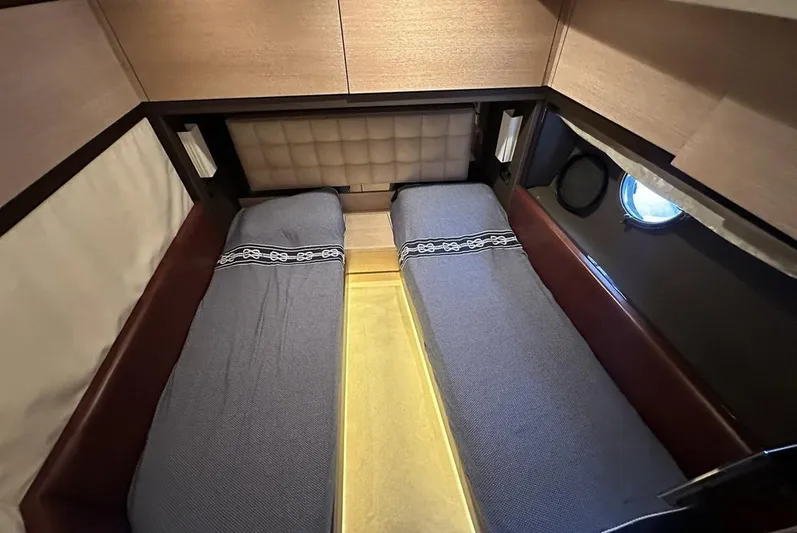  Yacht Photos Pics Twin cabin beds in a 2010 Azimut 70 yacht, featuring modern design and porthole window.