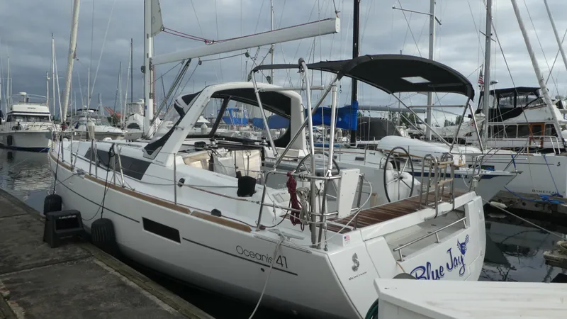  Yacht Photos Pics 2014 Beneteau Oceanis 41 sailboat docked at marina, overcast sky.