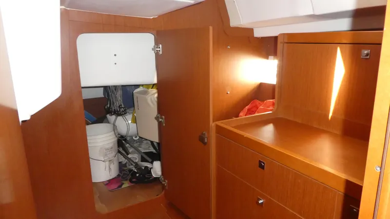  Yacht Photos Pics Interior of 2014 Beneteau Oceanis 41 sailboat with wooden cabinetry and storage area.