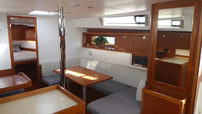  Yacht Photos Pics Interior of 2014 Beneteau Oceanis 41 sailboat with dining area and cozy cabin.