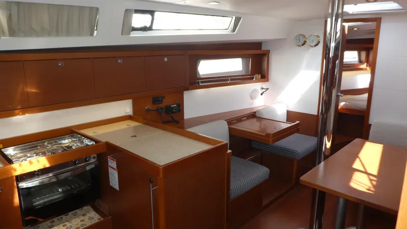  Yacht Photos Pics 2014 Beneteau Oceanis 41 interior with wood finish, dining area, and kitchen amenities.