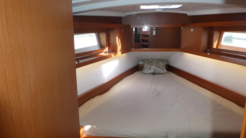  Yacht Photos Pics 2014 Beneteau Oceanis 41 cabin interior with bed, wooden finish, and windows.