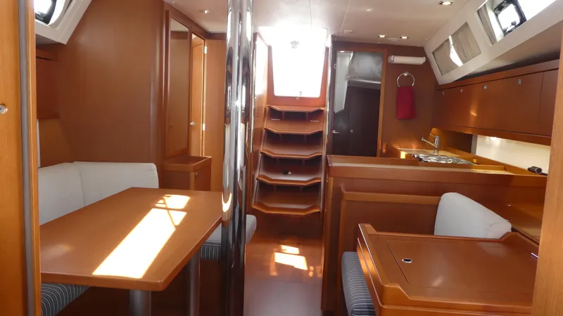  Yacht Photos Pics Interior of 2014 Beneteau Oceanis 41 sailboat with wood finish and dining area.