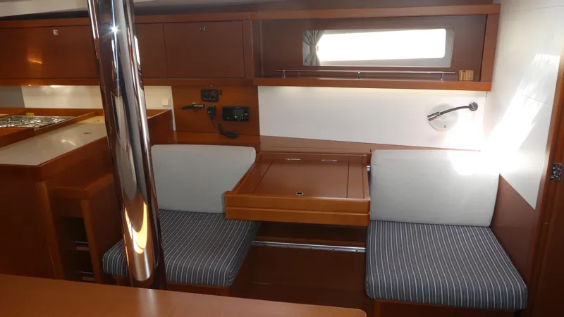  Yacht Photos Pics Interior of 2014 Beneteau Oceanis 41 sailboat with seating and table.