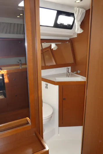  Yacht Photos Pics 2014 Beneteau Oceanis 41 yacht bathroom with wooden cabinetry and modern fixtures.