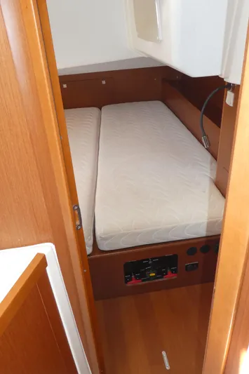  Yacht Photos Pics Cabin interior of 2014 Beneteau Oceanis 41 sailboat with twin beds and wooden finish.