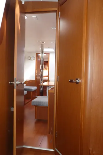  Yacht Photos Pics Interior view of 2014 Beneteau Oceanis 41 sailboat, featuring wooden doors and cozy cabin space.