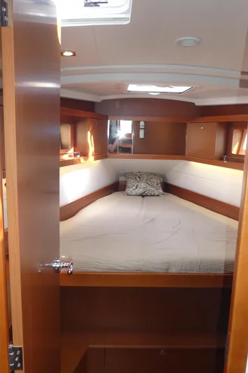  Yacht Photos Pics 2014 Beneteau Oceanis 41 cabin interior with cozy bed and wooden finish.